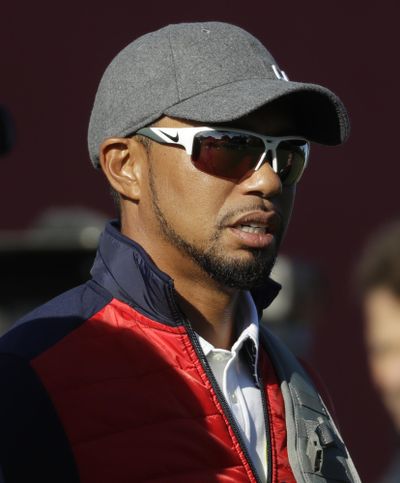 In this Sept. 27, 2016, file photo, United States vice-captain Tiger Woods watches a practice round for the Ryder Cup golf tournament, at Hazeltine National Golf Club in Chaska, Minn. Woods was appointed a vice captain for the 2018 Ryder Cup. Woods still wants to play on the team in Paris this September. (Chris Carlson / Associated Press)
