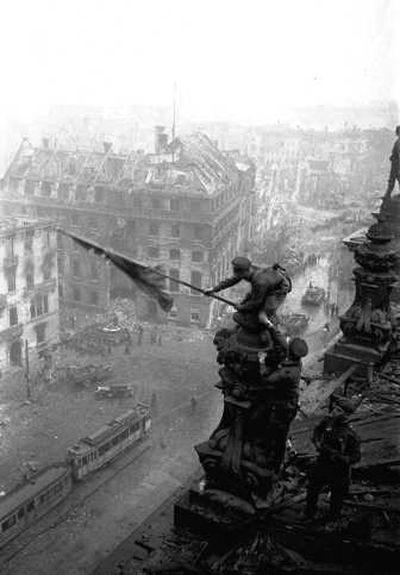 
Soviet soldiers hoist the red flag over the Reichstag   on May 2, 1945 – three days after it was captured. Associated Press
 (File Associated Press / The Spokesman-Review)