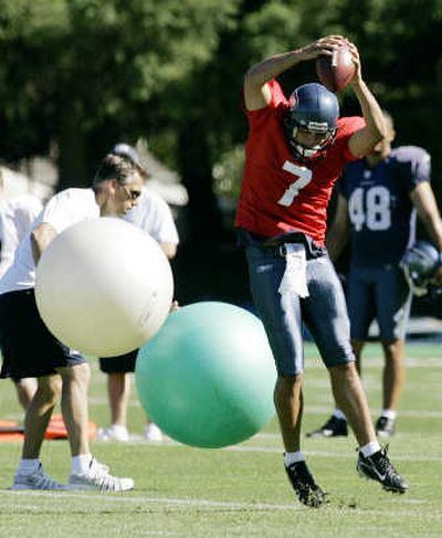 Seahawks backup and former Eastern Washington University quarterback Erik Meyer has been completing more passes on the sidelines than on the field. Here, he dodges balls thrown by quarterbacks coach Jim Zorn in a practice drill last week. Associated Press
(Associated Press / The Spokesman-Review)
