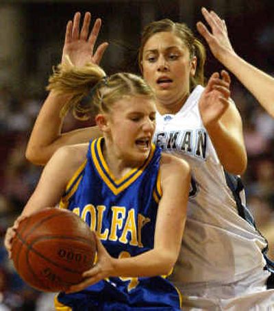 Colfax's Jordan Harazin, front, tries to get around Freeman's Jessie DePell during the first half of the State 1A tournament championship game Saturday.
 (Associated Press / The Spokesman-Review)