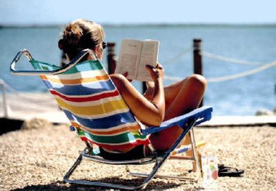
  There's nothing quite like reading a good book while lounging on the beach.
 (File photo / The Spokesman-Review)