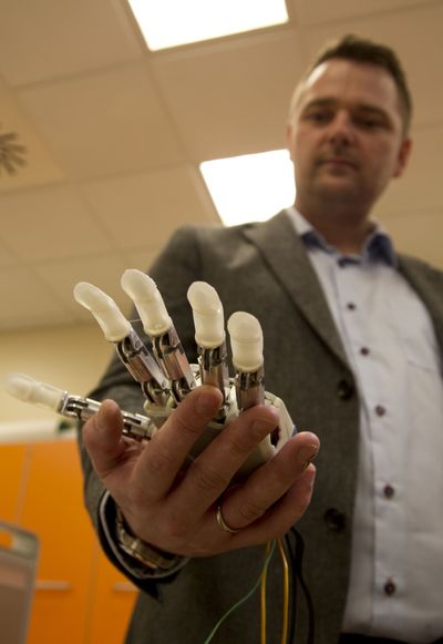 Dennis Aabo Sorensen, of Aalborg, Denmark, shows the sensory feedback-enabled prosthesis he is testing in Rome on Wednesday. (Associated Press)