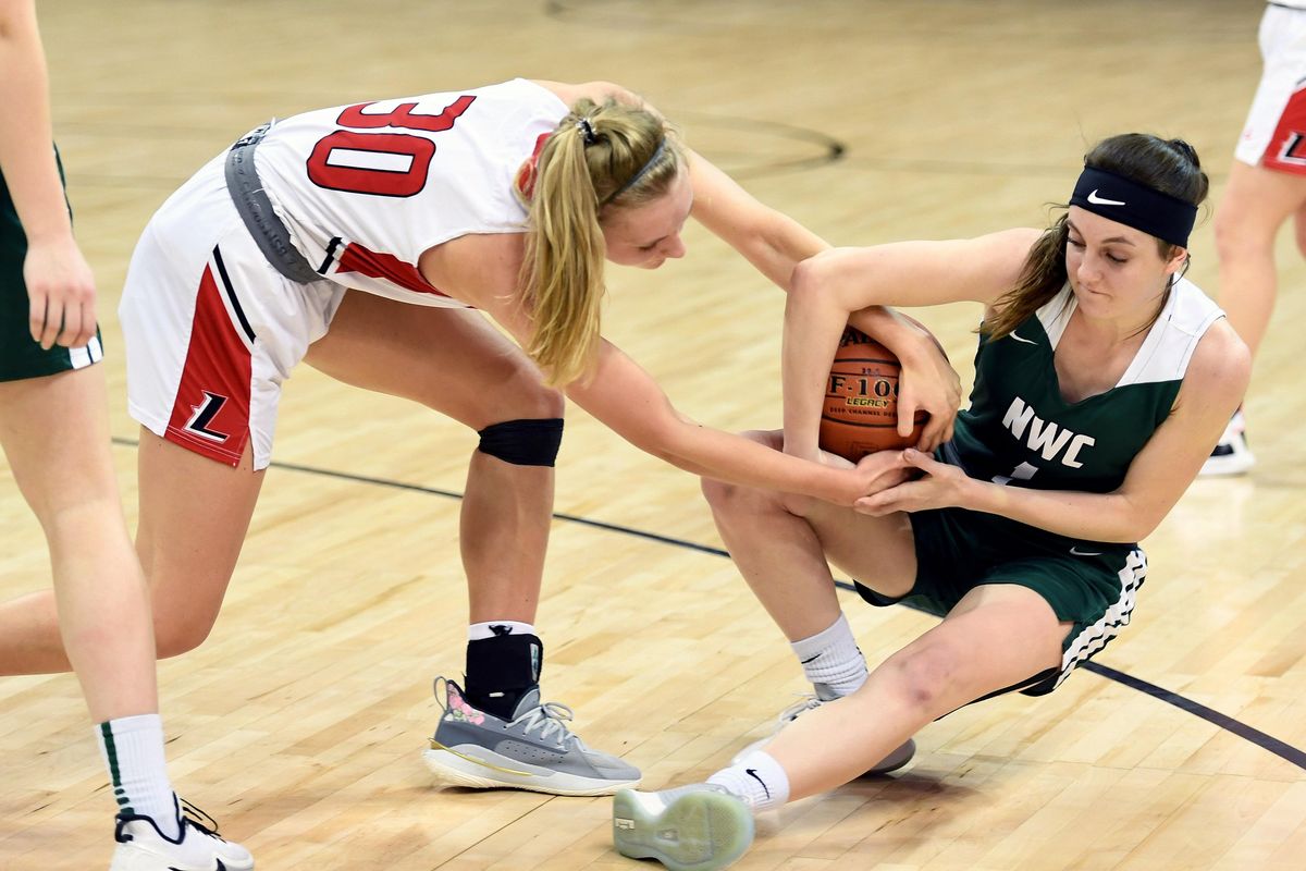 Liberty guard Aleena Cook (30) tries to take the ball away from Northwest Christian point guard Natalie Smith (1) during a WIAA State 2b semi-final Hardwood Classic basketball game, Friday, March 6, 2020, in the Spokane Arena. (Colin Mulvany / The Spokesman-Review)