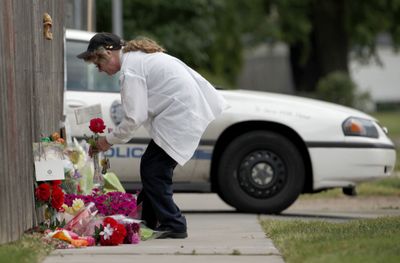 A woman places flowers on a memorial outside the Women’s Health Care Clinic in Wichita, Kan., on Monday.  (Associated Press / The Spokesman-Review)