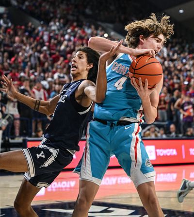 Gonzaga guard Dusty Stromer (4) grabs a rebound away from Yale forward Casey Simmons (14) during the second half of a NCAA college basketball game, Friday, Nov. 10, 2023, in the McCarthey Athletic Center.  (Colin Mulvany / The Spokesman-Review)