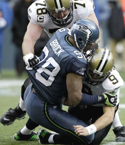  Saints quarterback Drew Brees is sacked by Seahawks’ Raheem Brock last Saturday.  (Associated Press)