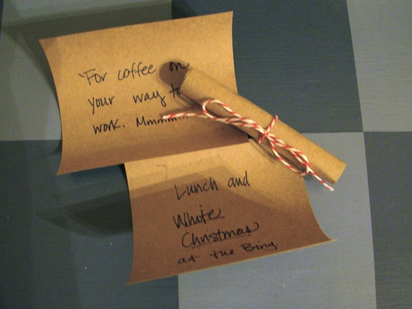 Write notes on brown paper and tie it with baker's string, then place one note in each stocking. (Maggie Bullock)