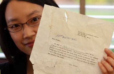 
Emily Shih holds the note sent in a 1987 class project that was recently found in Alaska. About 21 years passed between the time Shih put the message in a soda bottle and Merle Brandell picked it up on the beach. Associated Press
 (Associated Press / The Spokesman-Review)