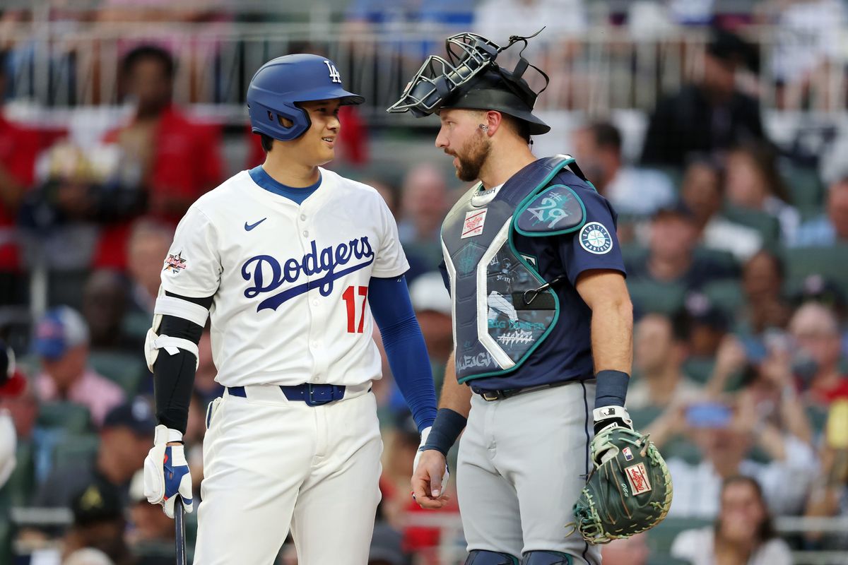 Shohei Ohtani of the Los Angeles Dodgers, left, and the Seattle Mariners’ Cal Raleigh speak during the first inning of Tuesday’s MLB All-Star Game in Atlanta.  (Kevin C. Cox)
