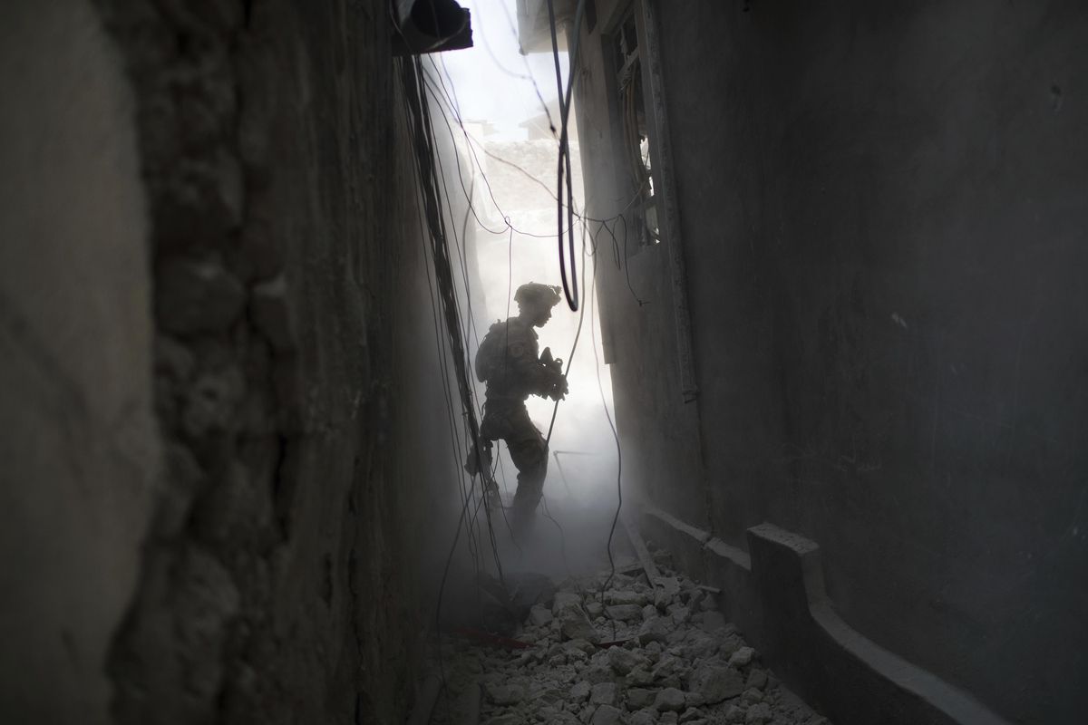 An Iraqi Special Forces soldier exchanges fire with Islamic State militants in the Old City of Mosul, Iraq, Friday, June 30, 2017. (Felipe Dana / Associated Press)