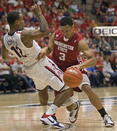 Washington State's Reggie Moore (3) is called for a charge while trying to dribble around Arizona's Lamont Jones (12) in the first half of their game in Tucson, Ariz., on Feb. 17, 2011.  (Wily Low / Fr53753 Ap)