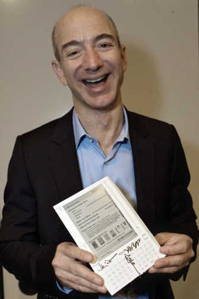 
Amazon.com chairman and CEO Jeff Bezos holds the Kindle, a portable reading device with the ability to wirelessly download books, blogs, magazines, and newspapers at the Book Expo America at the Los Angeles Convention on May 30.Associated Press
 (Associated Press / The Spokesman-Review)