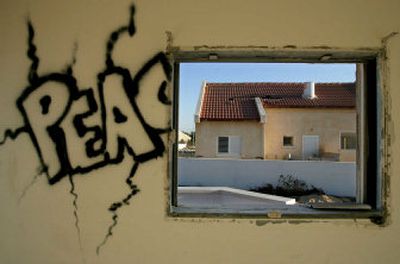 
Peace graffiti is painted inside an abandoned home in the Jewish settlement of Peat Sadeh in the southern Gaza Strip Gush Katif block of settlements, Saturday. 
 (Associated Press / The Spokesman-Review)