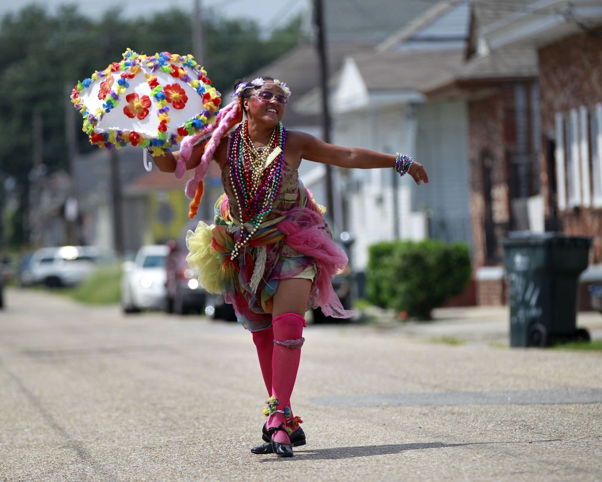 Jennifer Jones, a Grand Marshal for various bands and events, poses for a photo in the Treme section of New Orleans, Thursday, Aug. 23, 2012. The face of New Orleans is changing: Seven years after Hurricane Katrina the city many said would not recover is racially more diverse, and whiter, younger and richer; indicators not of failure but its success at reinventing itself. In fact, the city is experiencing a boom, and even gentrifying. (Gerald Herbert / Associated Press)