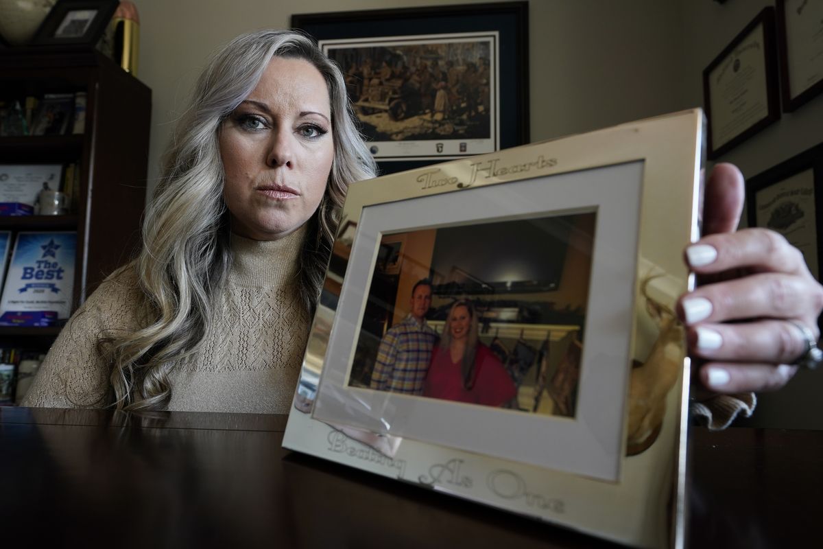 Jill Cichowicz, an advocate for opioid addiction treatment, displays a photo of her and her brother, Scott Zebnwski, who died of an opioid overdose at age 38, in her home in Midlothian, Va., Tuesday, Nov. 24, 2020. (Steve Helber)