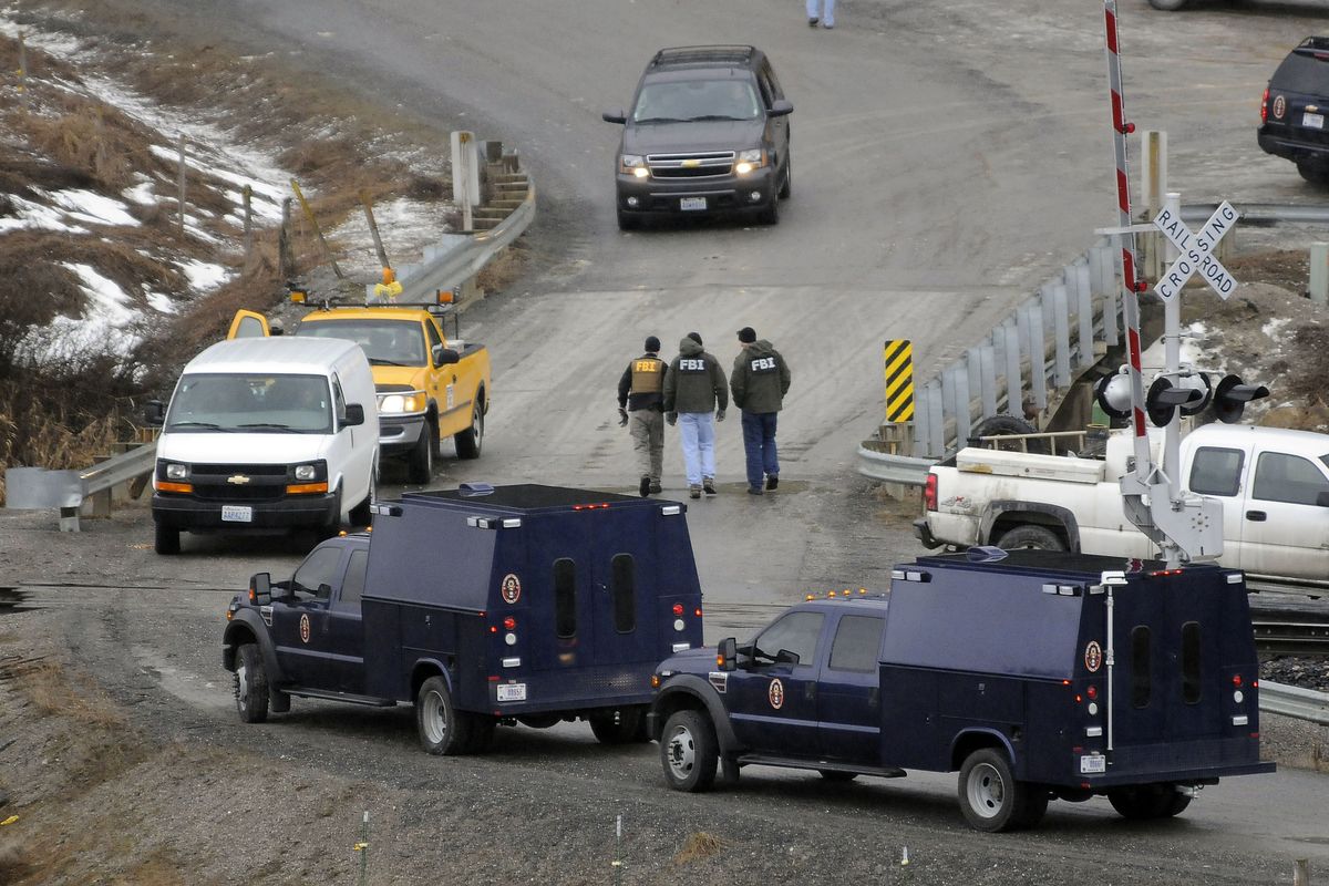 FBI agents cross the bridge on 12 Mile Road during their investigation of Kevin Harpham on March 9, 2011,  near Addy, Wash. (Dan Pelle / The Spokesman-Review)