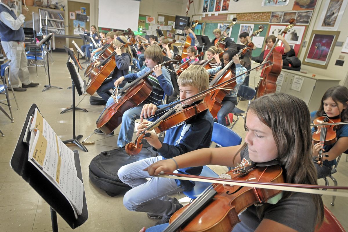 Isabella Lomas, foreground, plays her viola with the orchestra class taught by Angus Nunes, far left, at Jefferson Elementary School on Nov. 17. Funding for elementary music programs is likely in jeopardy if February’s levy fails. (Christopher Anderson)