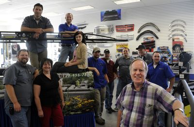 Owner Mike Dalton, foreground at right, stands with his staff at Quality Auto Trim’s new location in Spokane Valley July 14. The new, larger building is on Appleway Boulevard, just a few blocks from the other  location. The staff includes, from left, Steve Morgan, Lance Shew, Elena Karl, Con Shiva, Lara Paulson, Joshua Adams, Bob Finley, Max Shiva, Dalton, Adam Bennett and Drew Snow. (Jesse Tinsley / The Spokesman-Review)