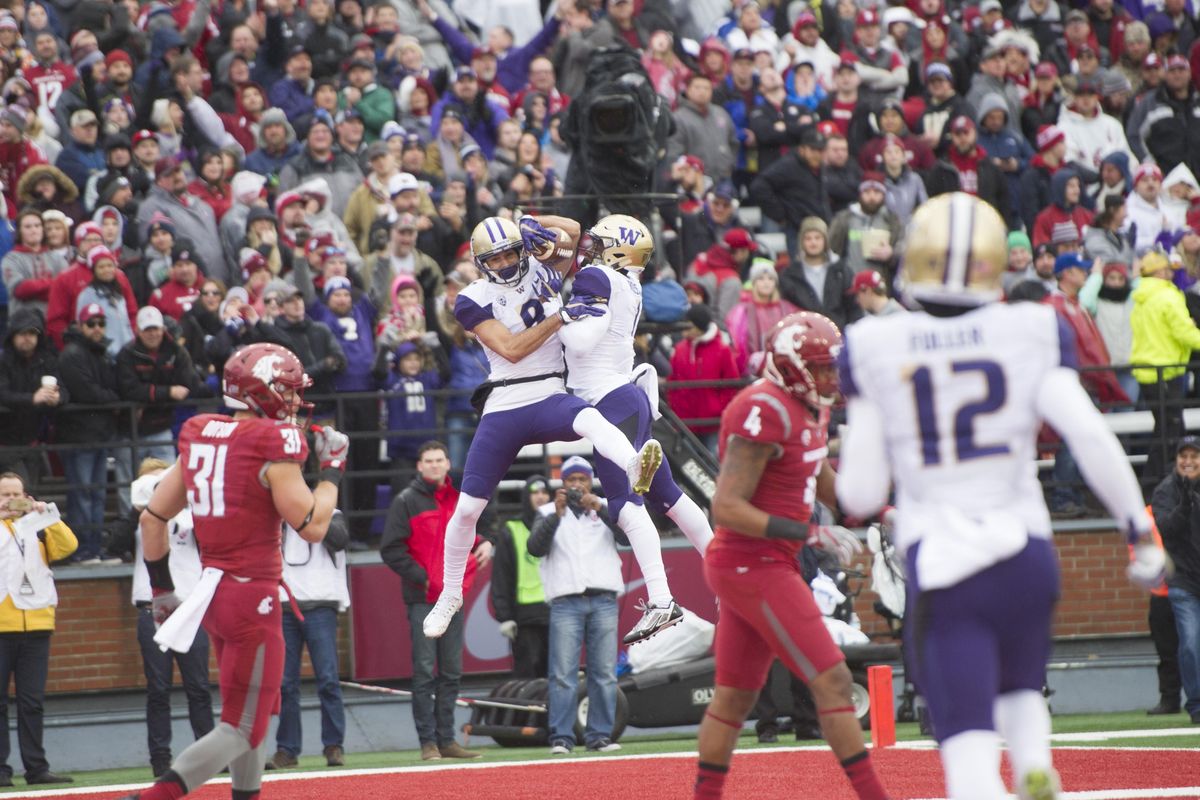 Washington Huskies wide receiver Dante Pettis (8) reacts after scoring against WSU during the first half of the 2016 Apple Cup on Friday, Nov 25, 2016, at Martin Stadium in Pullman, Wash. (Tyler Tjomsland / The Spokesman-Review)