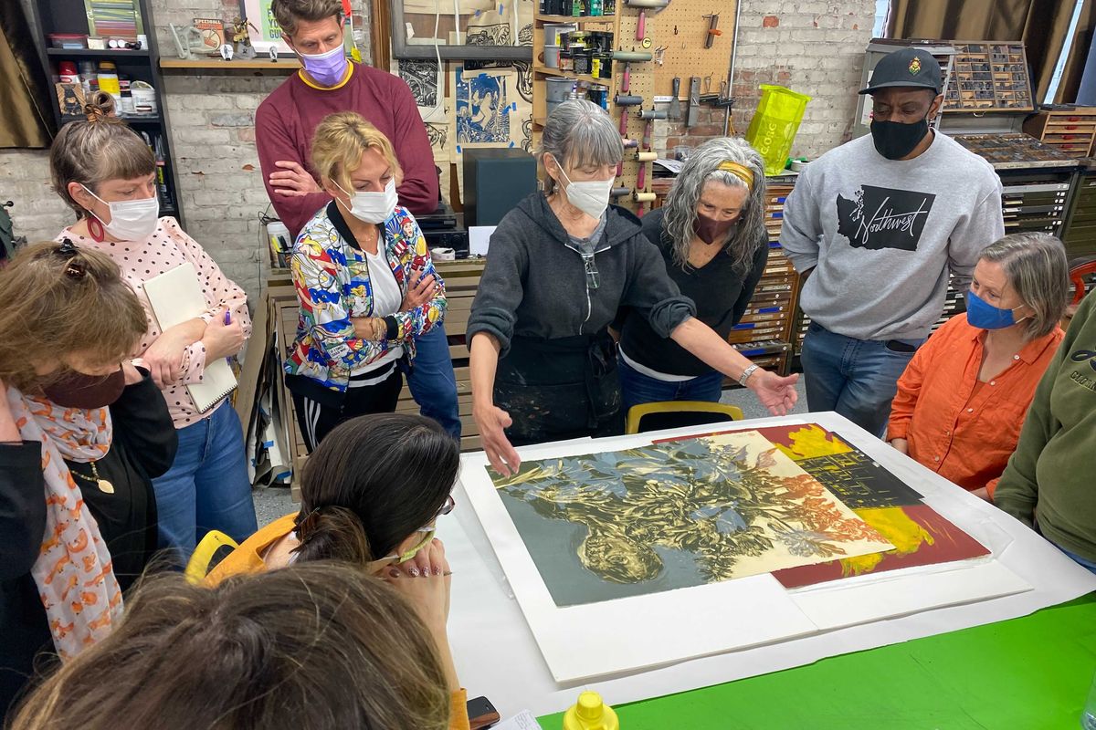 Artists look over the shoulder of Sophia S.W. Bogle as she hosts a book binding class for at Spokane Print and Publishing Center as part of a previous Spokane Print Fest.  (Courtesy of Reinaldo Gil Zambrano)