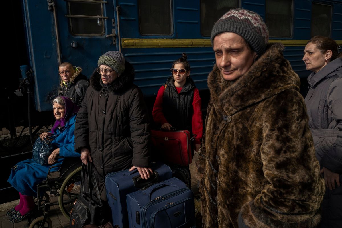 Ukrainians escaping from the besieged city of Mariupol along with other passengers from Zaporizhzhia arrive at Lviv, western Ukraine, on Sunday. (Bernat Armangue)
