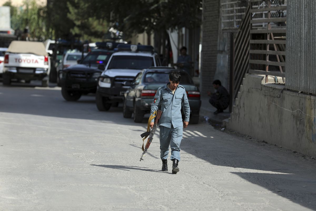 Afghan security personnel arrives at the area where the director of Afghanistan