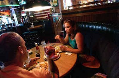 
Brian Sykora and Marilyn Huecas eat lunch in the bar at Crickets, a downtown eatery. The new no-smoking law bans smoking in restaurants, but bars are exempt, so Crickets decided to go all nonsmoking until 10 p.m., then allow smoking after hours. 
 (Jesse Tinsley / The Spokesman-Review)