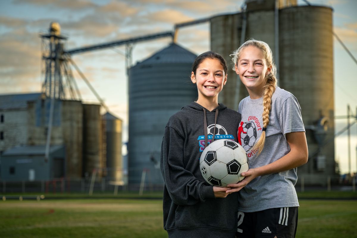 Sisters Charlotte, on left, and Glenna Soliday run cross country and play soccer in the same season for Davenport High School.  (COLIN MULVANY)