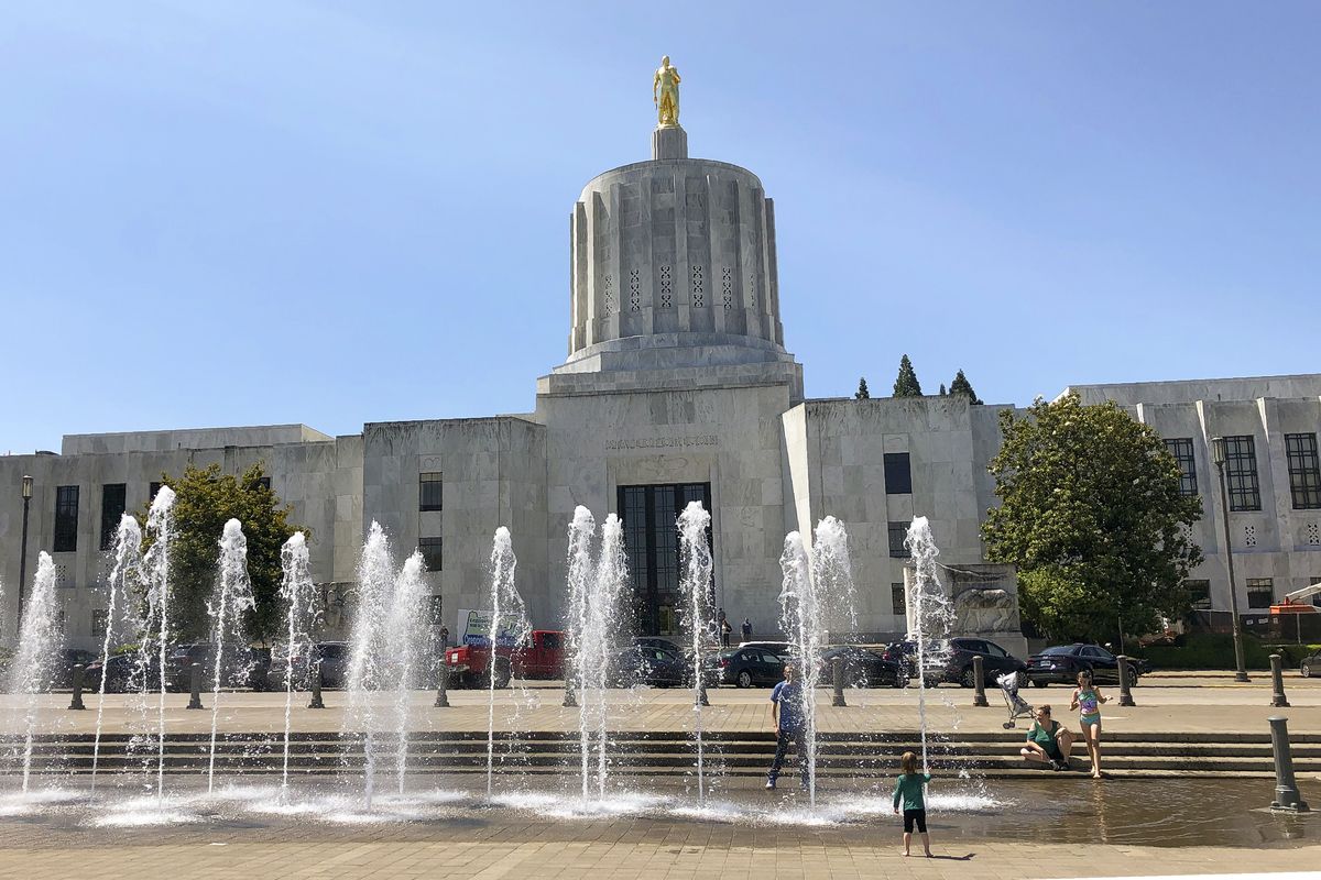 Children play in fountains June 29, 2019, at the Oregon State Capitol in Salem, Ore.  (Associated Press)
