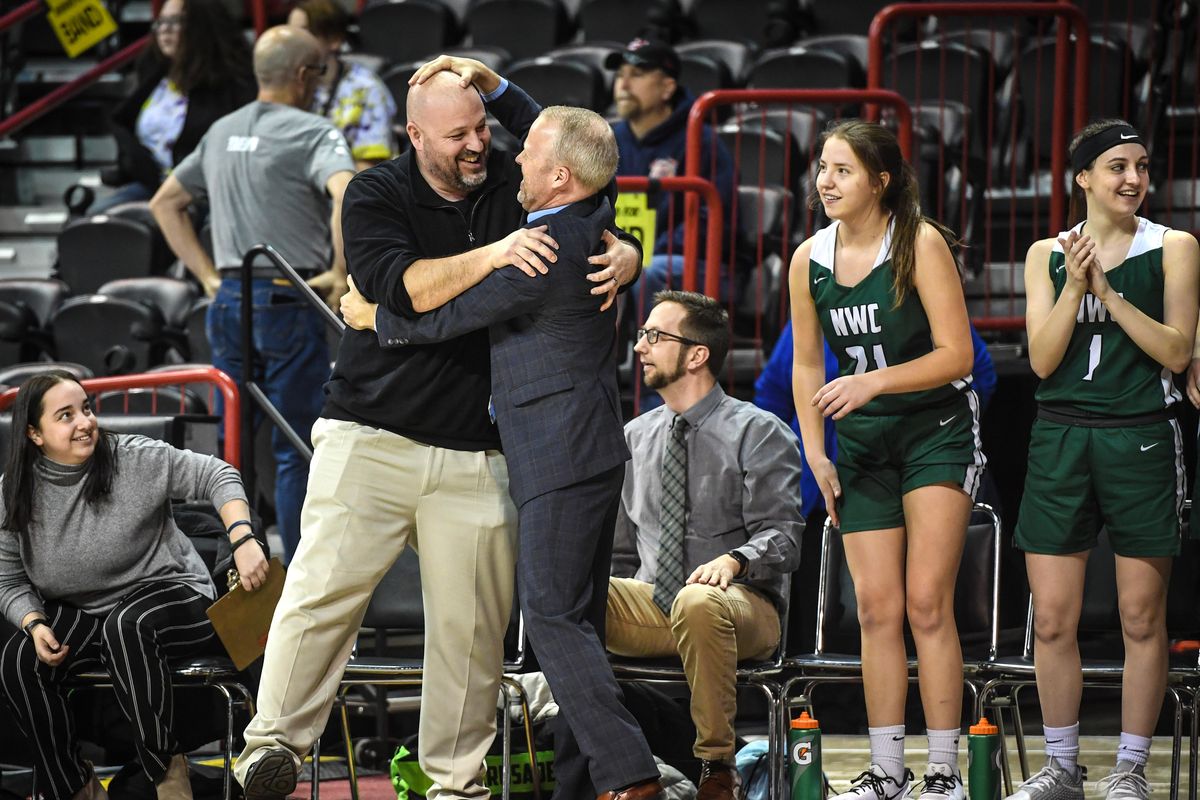 Northwest Christian assistant coach Ken Ryan, left, gets his head rubbed by head coach Geoff Tibbets at the final buzzer after defeating Ilwaco 50-37, Thursday, March 5, 2020 at the 2B Girls Hardwood Classic in the Spokane Arena. (Dan Pelle / The Spokesman-Review)