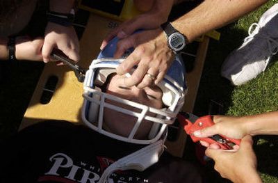 
Heather Case, 19, has a football helmet cut off her during Whitworth Athletic Training Orientation at Whitworth College. The four-day orientation prepares athletic training students for the arrival of the varsity athletes next week. The program is an example of how students are being trained to keep each other healthy.
 (Jed Conklin / The Spokesman-Review)