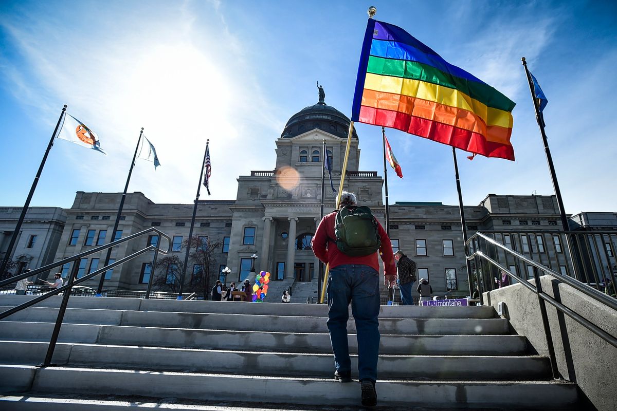 FILE - In this March 15, 2021 photo, demonstrators gather on the steps of the Montana State Capitol protesting anti-LGBTQ+ legislation in Helena, Mont. Montana health officials say transgender people can't change their birth certificates even if they undergo surgery, in defiance of a court order that temporarily blocked the Republican state's bid to restrict transgender rights.  (Thom Bridge)
