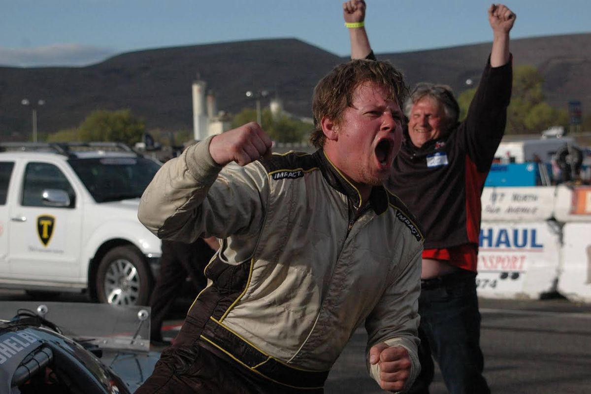 Shelby Thompson celebrates after exiting his car following his victory at the 49th Apple Cup at Yakima Speedway.