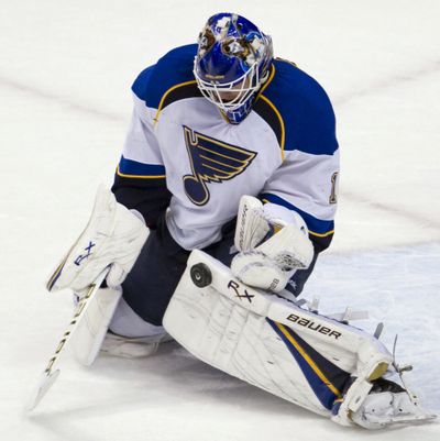 St. Louis Blues goaltender Brian Elliott makes one of his 32 saves against the Vancouver Canucks on Wednesday. (Associated Press)