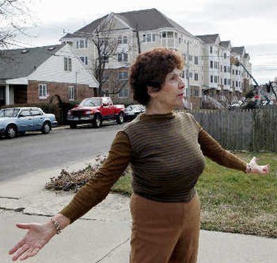 
Rose LaRosa stands in front of her home near the construction of new condominiums in Long Branch, N.J., on Wednesday. If LaRosa doesn't willingly sell the home that she grew up in, officials are going to use eminent domain to take it. 
 (Associated Press / The Spokesman-Review)
