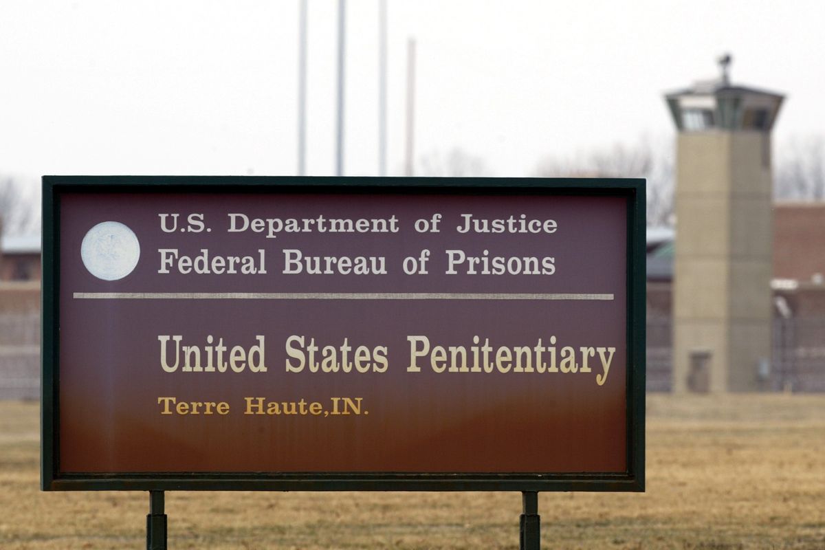 FILE - In this March 17, 2003 oil photo, a guard tower flanks the sign at the entrance to the U.S. Penitentiary in Terre Haute, Ind. After the latest 17-year hiatus, the Trump administration wants to restart federal executions this month at the Terre Haute, prison. Four men are slated to die. All are accused of murdering children in cases out of Arkansas, Kansas Iowa and Missouri.  (MICHAEL CONROY)