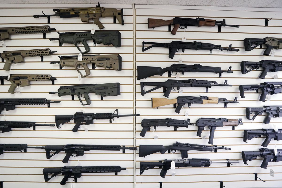FILE - In this Oct. 2, 2018, file photo, semi-automatic rifles fill a wall at a gun shop in Lynnwood, Wash.   (Elaine Thompson)
