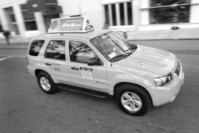 
New York City Mayor Michael Bloomberg announced Tuesday that by 2012 all the city's taxis will be hybrids like this Ford Escape. 
 (Associated Press / The Spokesman-Review)