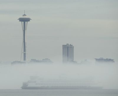 A passing ferry boat is shrouded in fog as it passes the Space Needle on Elliott Bay, Wednesday, Sept. 15, 2010, in Seattle. (Ted Warren / Associated Press)