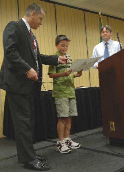 
Cooper Brown (right) looks at his first-place entry along with Glen Carey, chair of the contest committee. 
 (Don Walker / The Spokesman-Review)
