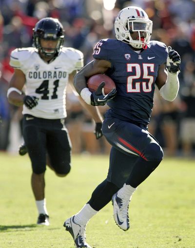 Arizona’s Ka’Deem Carey, right, ran for five touchdowns and set a Pac-12 record with 366 rushing yards against Colorado. (Associated Press)