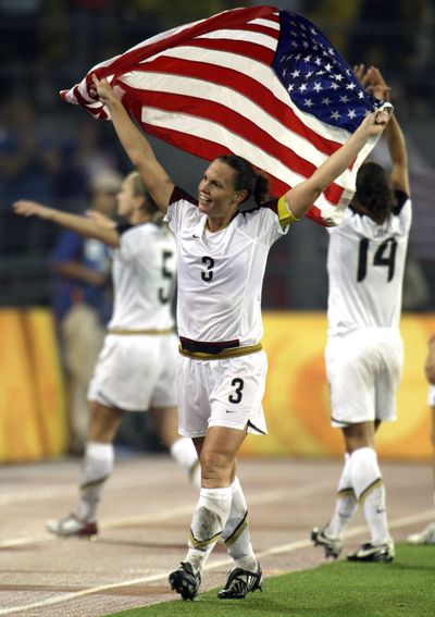 United States' Christie Rampone waves the Star Spangled Banner after they beat Brazil in the women's soccer gold medal match at the Beijing 2008 Olympics in China Thursday, Aug. 21, 2008. (Roberto Candia / Associated Press)