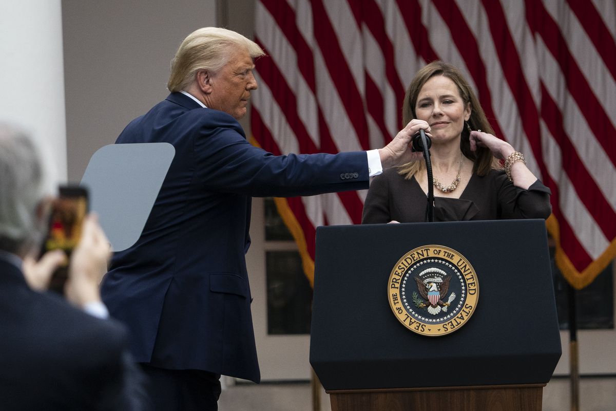President Donald Trump adjusts the microphone after he announced Judge Amy Coney Barrett as his nominee to the Supreme Court, in the Rose Garden at the White House, Saturday, Sept. 26, 2020, in Washington.  (Alex Brandon)