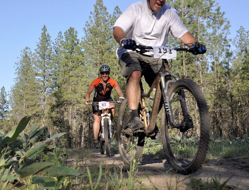 Ammi Midstokke, left, a solo rider from Sandpoint, tops a steep hill during the 24 Hours Round the Clock mountain bike race on May 23, 2015, at Riverside State Park.  (Rich Landers)