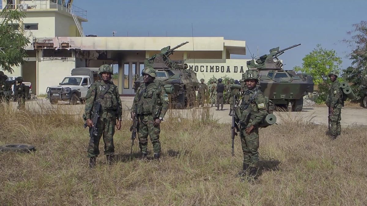 In this image made from video, Rwandan soldiers gather at the airport in Mocimboa da Praia, Cabo Delgado province, Mozambique, Monday, Aug. 9, 2021. Fresh from recapturing the strategic northern Mozambican port of Mocimboa da Praia held by Islamic extremist rebels for a year, Rwandan and Mozambican troops say they are pursuing the insurgents into the surrounding areas. (Marc Hoogsteyns)