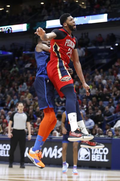 New Orleans Pelicans forward Anthony Davis (23) collides with Oklahoma City Thunder forward Nerlens Noel (3) after attempting to block a shot at the end of the first half of an NBA basketball game in New Orleans, Thursday, Feb. 14, 2019. Davis kept his left arm still as he walked to the locker room shortly after fouling Noel on an attempted shot block with his left hand. When the second half began, the Pelicans announced that Davis was out of the remainder of the game with a left shoulder injury. (Tyler Kaufman / Associated Press)