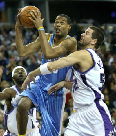 
Denver's Marcus Camby drives to the hoop past Sacramento's Brad Miller.Associated Press
 (Associated Press / The Spokesman-Review)