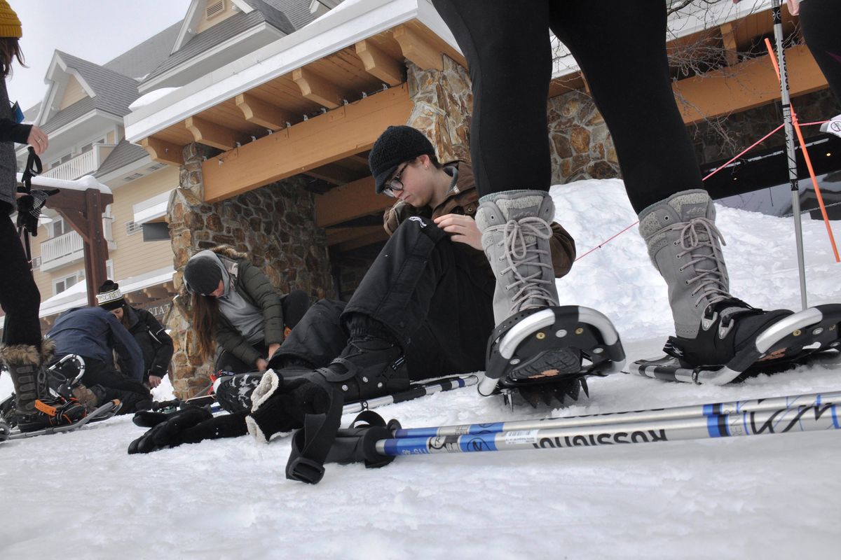 Participants gear up for a snowshoe trek hosted by the Activities Center at Schweitzer Mountain Resort. (Rich Landers / The Spokesman-Review)