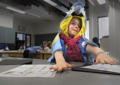 Linnea Sunderman shows how a superpower bird would fly during Camp Invention at Moran Prairie Elementary in Spokane on Thursday. (Christopher Anderson / The Spokesman-Review)