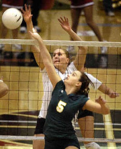 
Sacramento State's Stephanie Gamst tips the ball out of reach for Eastern Washington's Megan Kitterman.
 (Holly Pickett / The Spokesman-Review)